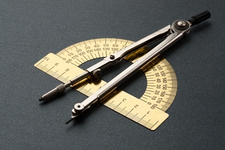 Pair of compasses and protractor isolated on whiteの写真素材
