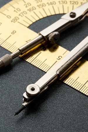 Pair of compasses and protractor isolated on white