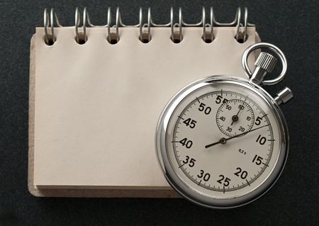 Notepad and stopwatch isolated on dark background の写真素材