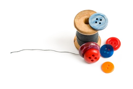 Thread bobbin and buttons isolated on white backgroundの写真素材