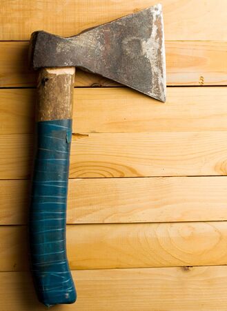 Axe isolated on wooden backgroundの写真素材