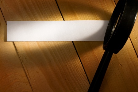 Magnifying glass isolated on wooden background の写真素材