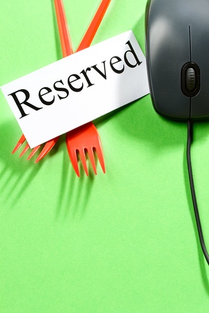 Forks, computer mouse and card on green backgroundの写真素材