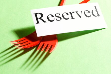 Forks and card on green backgroundの写真素材