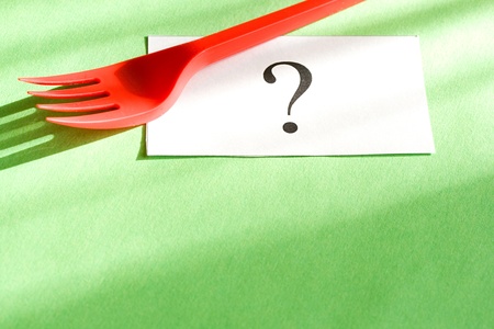 Fork and card isolated on green backgroundの写真素材