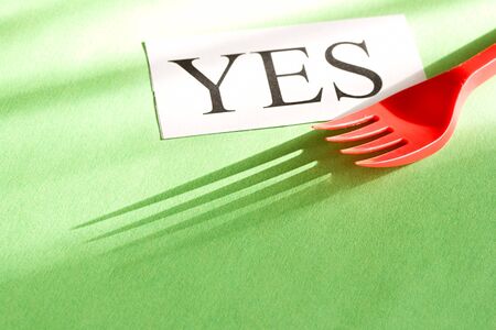 Fork and card isolated on green backgroundの写真素材