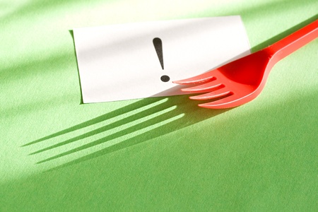 Fork and card isolated on green backgroundの写真素材