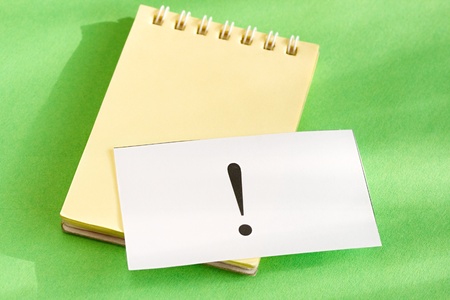 Notepad and card isolated on green backgroundの写真素材