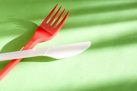 Fork and knife isolated on green backgroundの写真素材
