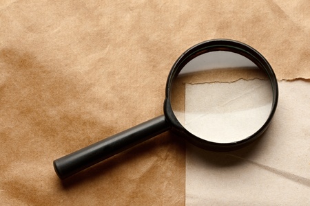 Magnifying glass on paper backgroundの写真素材