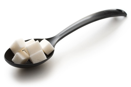 Sugar in a spoon isolated over white background の写真素材