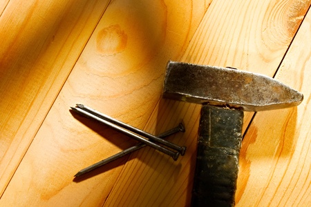 Hammer and nails isolated on the wooden backgroundの写真素材
