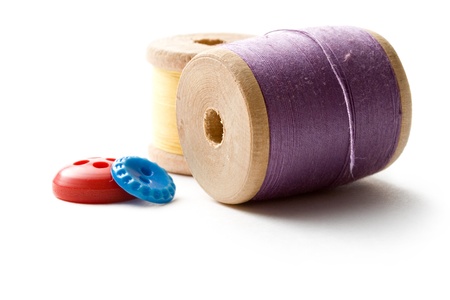 Thread bobbins and buttons on the white background の写真素材