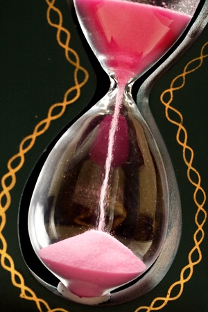 A sand glass on blackの写真素材