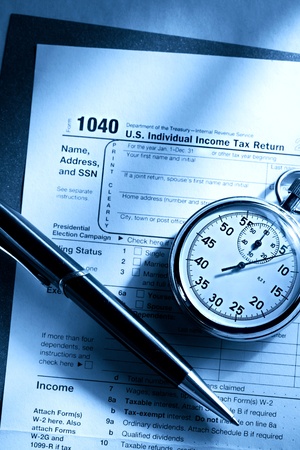 Tax form, pen and stopwatchの写真素材