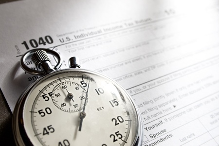 Tax form and stopwatchの写真素材
