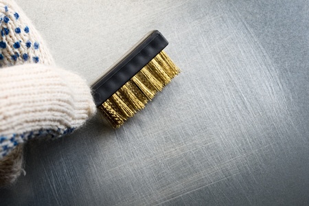 Metal brush on steel backgroundの写真素材