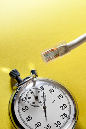 cable and stopwatch on yellowの写真素材