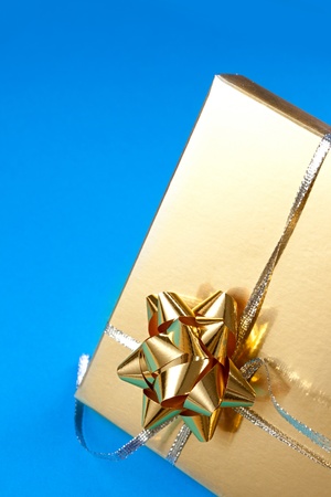 Decorated gift box on the blue background の写真素材