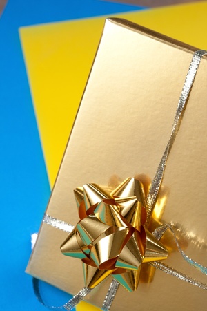 Decorated gift box on blue and yellow paperの写真素材