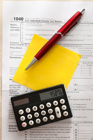 Tax form, red pen, calculator and stickerのeditorial素材