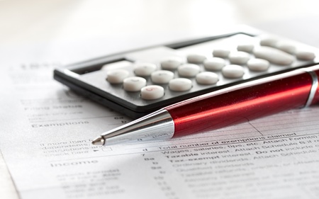 Tax form, red pen and calculator の写真素材