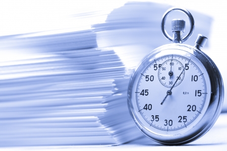Pile of paper cards and stopwatch in blue