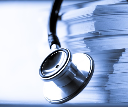 Stethoscope and heap of paper cardsの写真素材