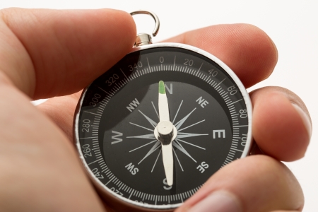Hand holding silver black compassの写真素材