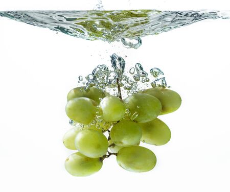 Green grape in water splashの写真素材
