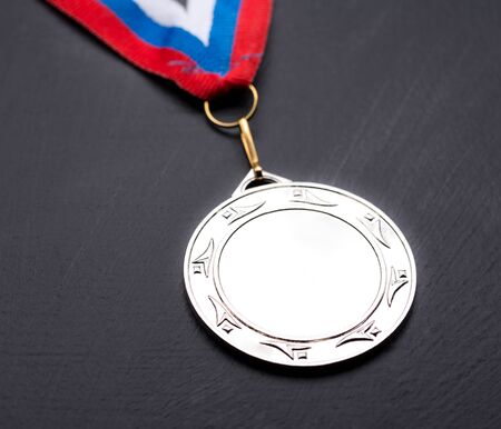 Metal medal with tricolor ribbon の写真素材