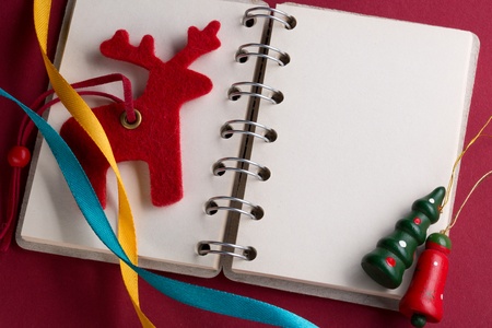 Open notebook with ribbons and reindeerの写真素材