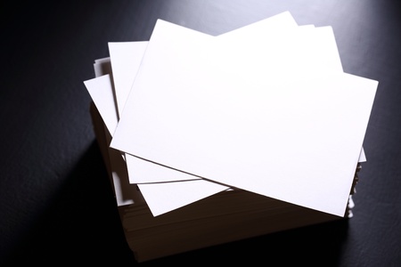 Stack of white paper cards on blackの写真素材
