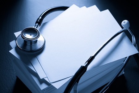 Stethoscope and heap of paper cards の写真素材