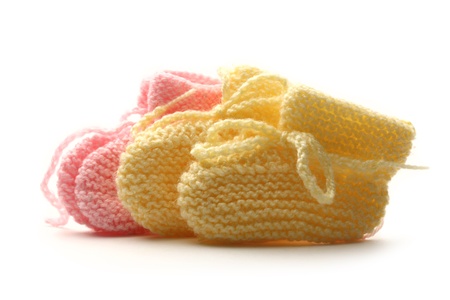 Baby bootees on white background