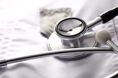 Stethoscope on white medical coatの写真素材