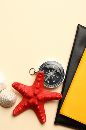 Compass, seastar and seashells on notebookの写真素材