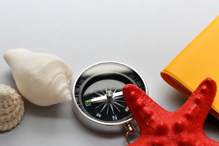 Compass, seastar and seashells on notebookの写真素材
