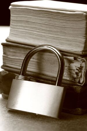 Pile of old books and keylock の写真素材