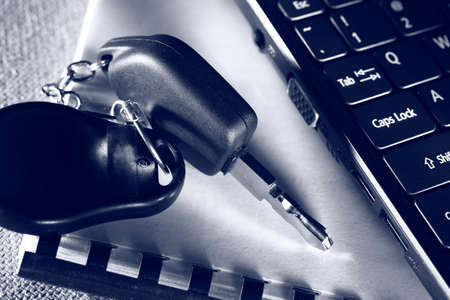 Notebook, car key and computer keyboard の写真素材