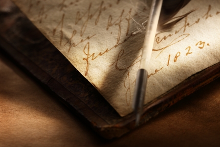 Old book with feather penの写真素材