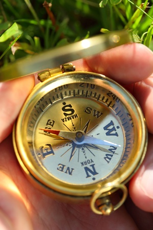 Golden compass in male handの写真素材