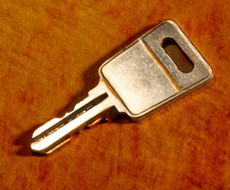Metal key on iron background