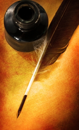 Feather ink bottle on paperの写真素材