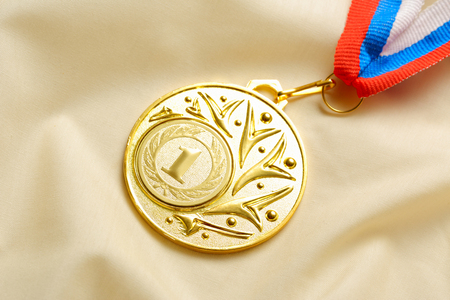 Metal medal on silk wrinkled clothの写真素材