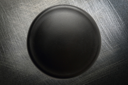 Black button on steel scratchy の写真素材