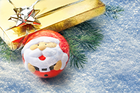 Gift with fir and santa ball on snow backgroundの写真素材