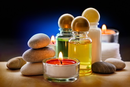 Spa stones, candle and shampoo bottlesの写真素材