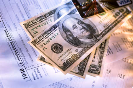 Credit card and dollars on tax form
