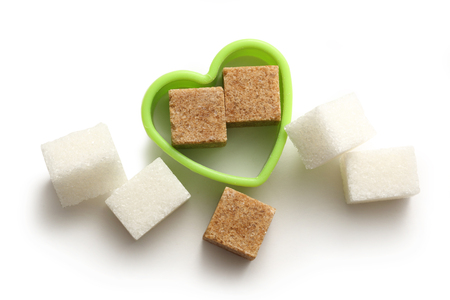 Cane and white sugar cubes in heart formの写真素材